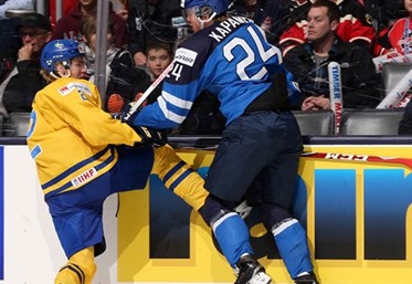 TORONTO, CANADA - JANUARY 2: Sweden's Sebastian Aho #2 takes a hit from Finland's Kasperi Kapanen #24 during quarterfinal round action at the 2015 IIHF World Junior Championship. (Photo by Andre Ringuette/HHOF-IIHF Images)